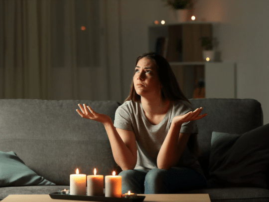 woman sitting on couch during a power outage